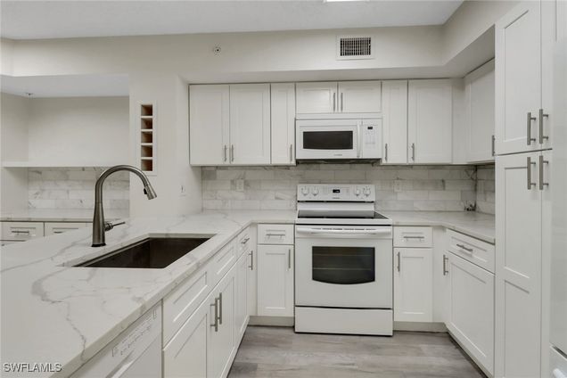 1220 Wildwood Lakes Boulevard Unit 108 Naples, FL Condo Active - Photo 1 of 40. Opens carousel modal